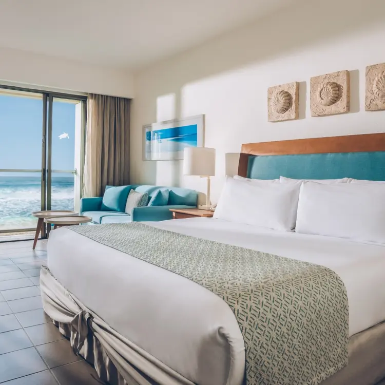 Oceanfront suite with balcony and turquoise decor at Iberostar Selection Cancun