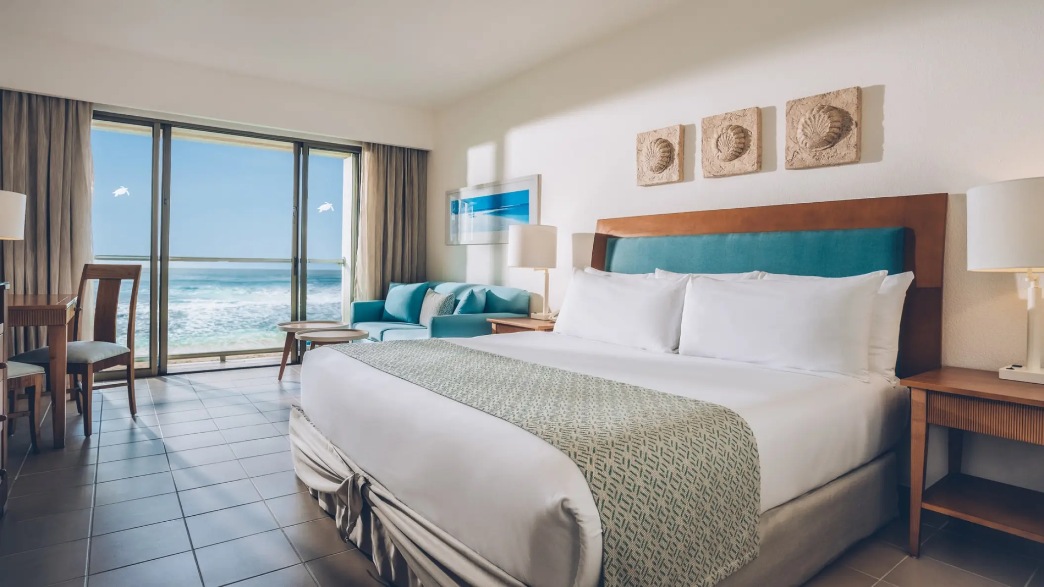 Oceanfront suite with balcony and turquoise decor at Iberostar Selection Cancun