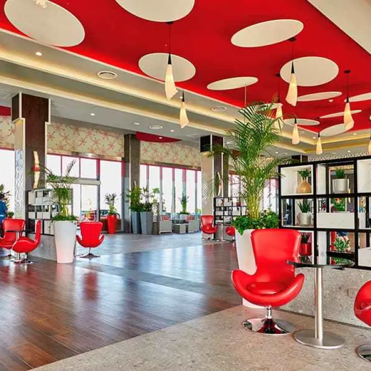 Modern lobby with red accents and circular ceiling panels at Riu Palace Costa Mujeres, Cancun