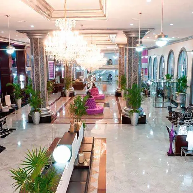 Grand lobby with crystal chandeliers and arched windows at Riu Palace Mexico, Playa Del Carmen