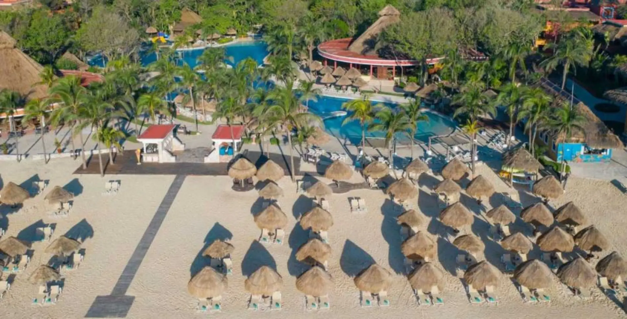 Aerial view of the beachfront pool and palapas at Iberostar Waves Tucan, Playa Del Carmen