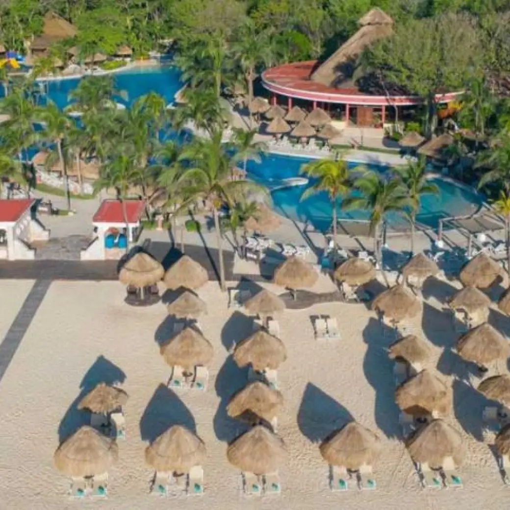 Aerial view of the beachfront pool and palapas at Iberostar Waves Tucan, Playa Del Carmen