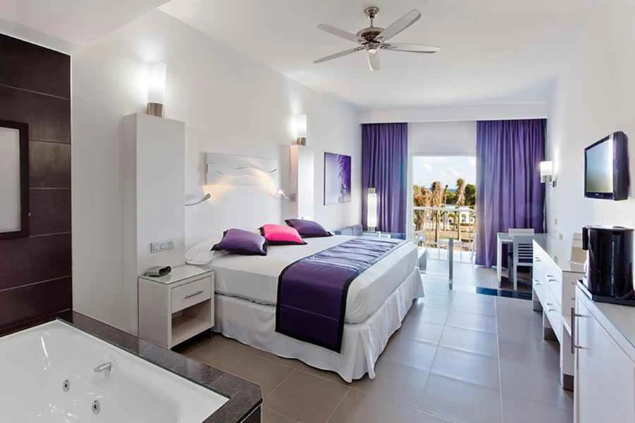 Modern suite with purple accents and a balcony at Riu Palace Mexico, Playa Del Carmen