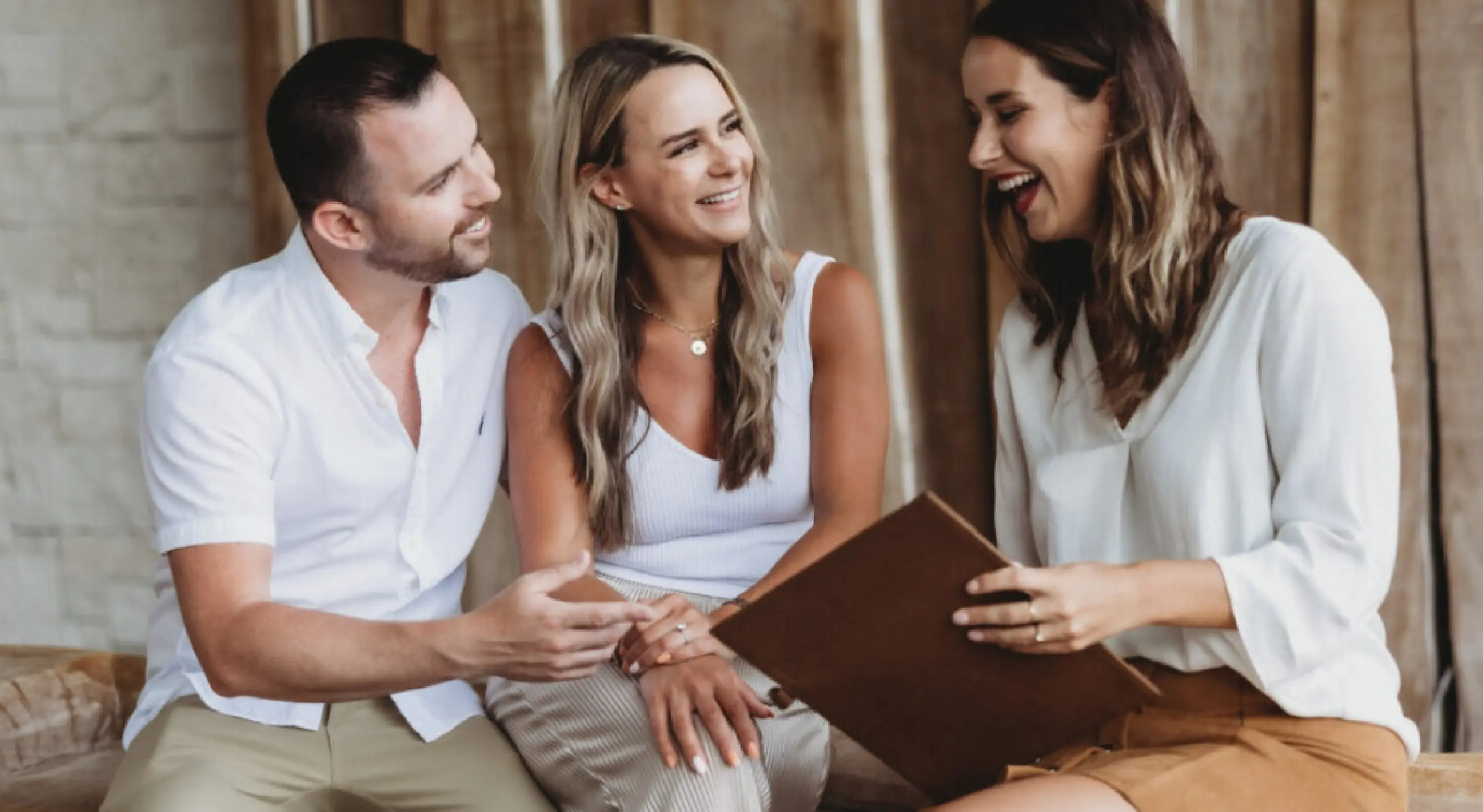 Paradise Weddings planner laughing with a couple during a destination wedding consultation