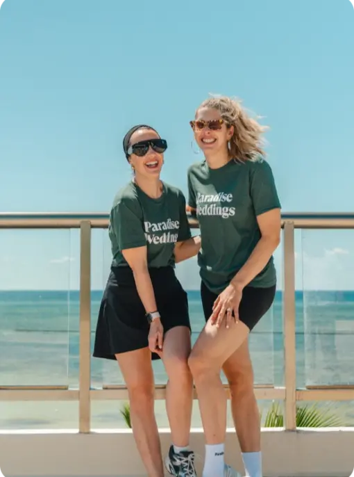 Paradise Weddings planners laughing on a terrace overlooking the ocean