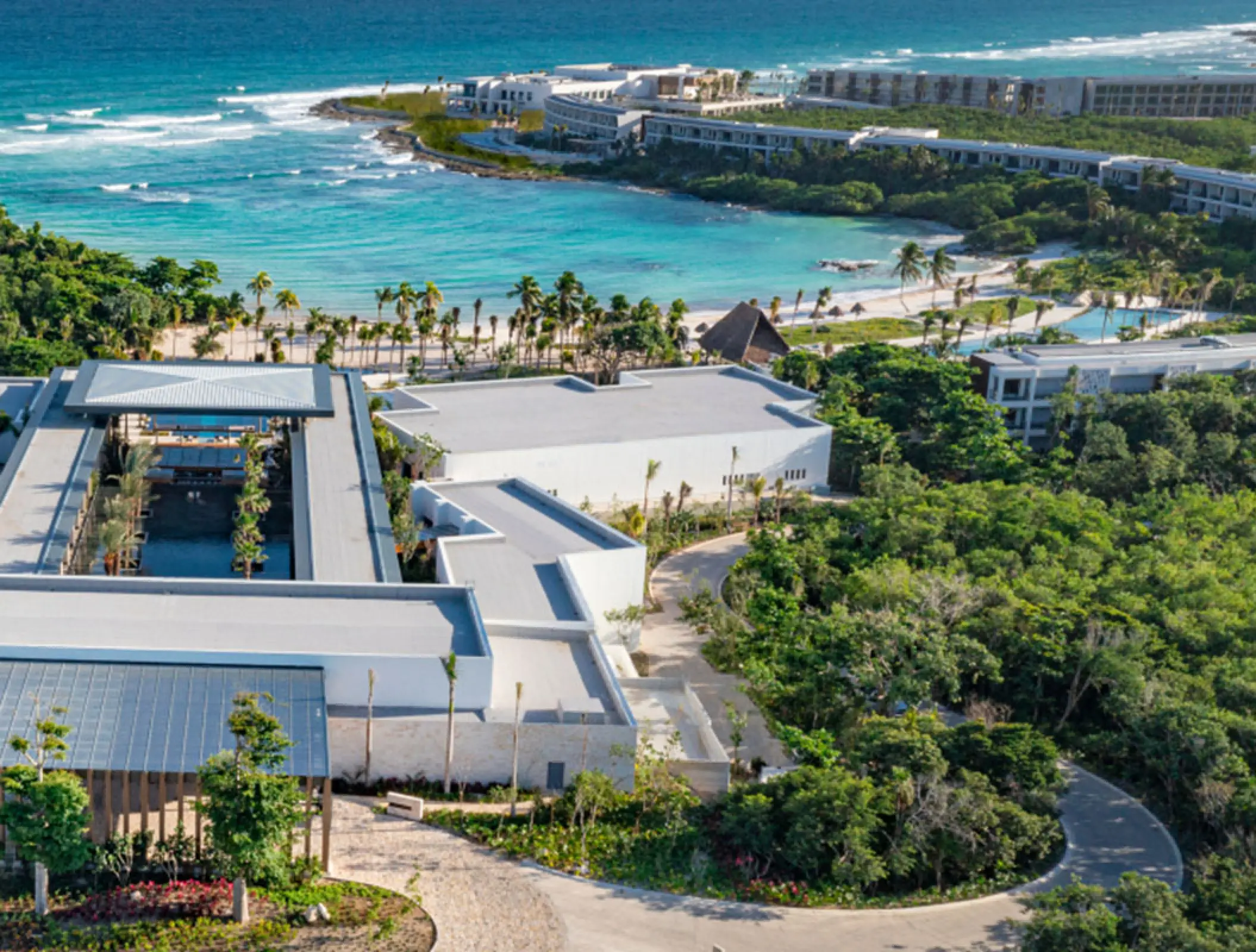 Aerial view of Conrad Tulum oceanfront grounds and turquoise bay, Tulum