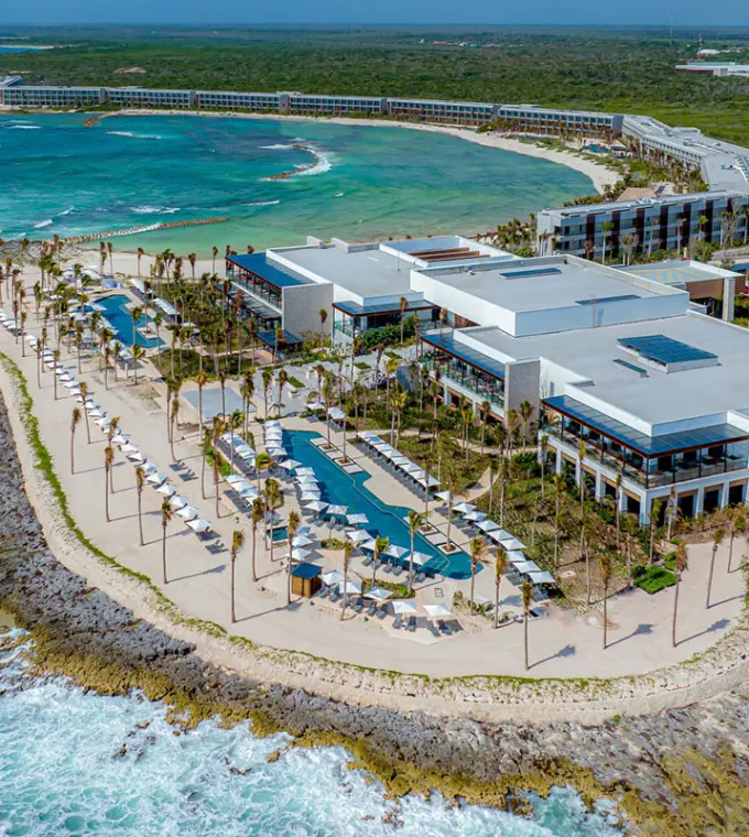 Aerial view of Hilton Tulum beachfront buildings and pools overlooking the bay, Tulum