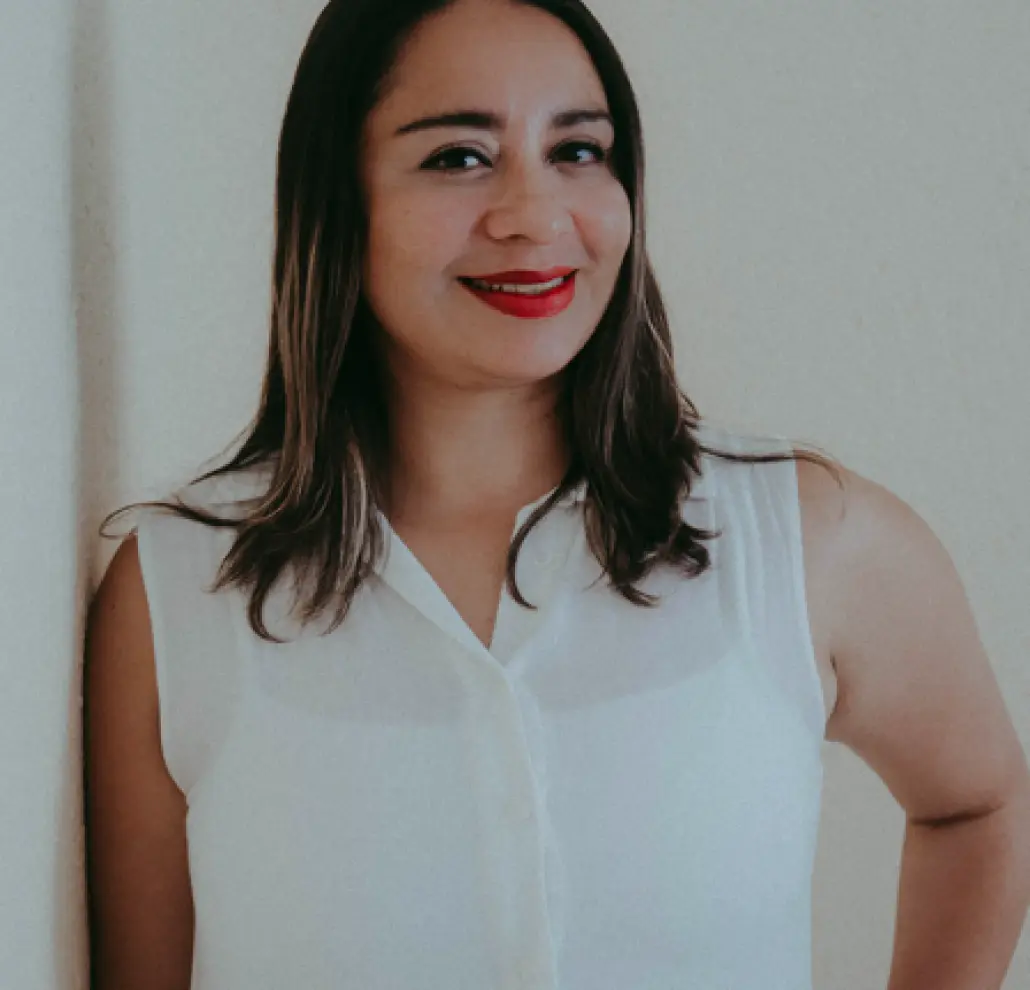 Paradise Weddings planner smiling in a white sleeveless blouse