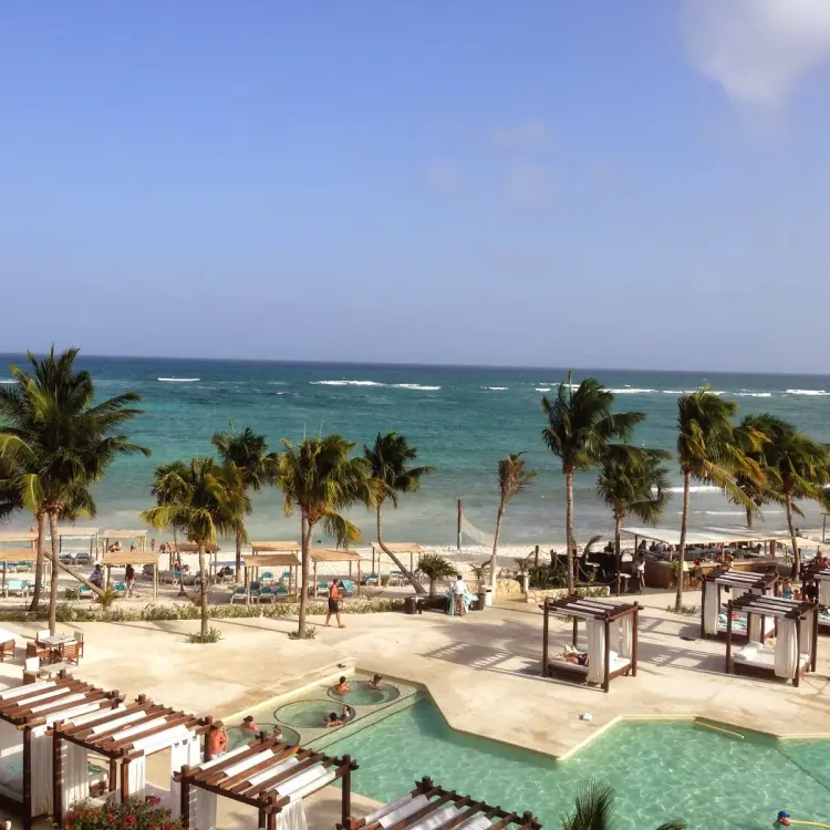 Akumal Bay Beach & Wellness Resort pools and beach cabanas overlooking the Caribbean Sea, Riviera Maya