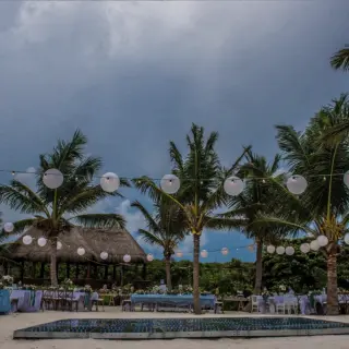 Beachfront wedding reception with string lights and dance floor at Akumal Bay Beach & Wellness Resort, Riviera Maya