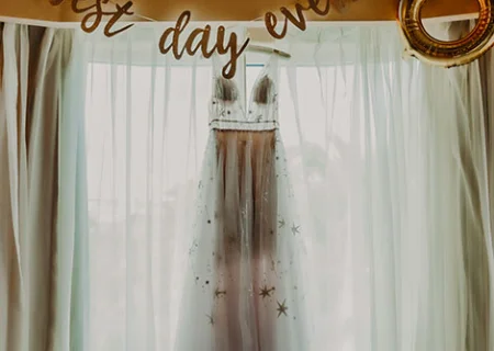 bridal dress hanging on window