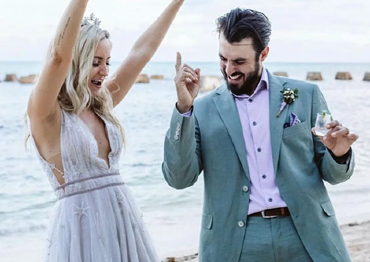 Newlyweds have fun on the beach
