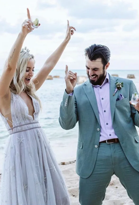 Newlyweds have fun on the beach