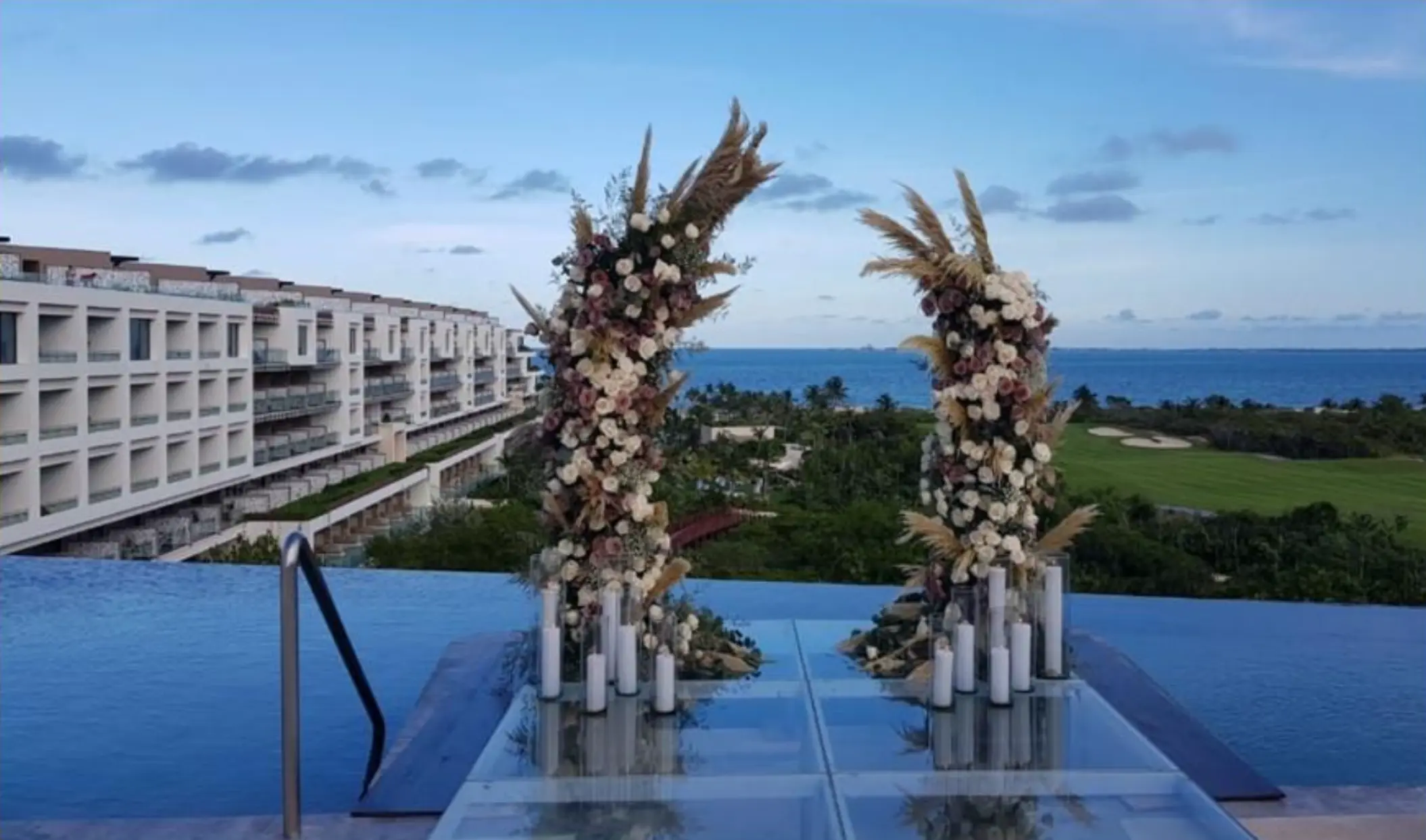 Rooftop terrace wedding ceremony setup with pampas grass arch at Atelier Playa Mujeres, Cancun