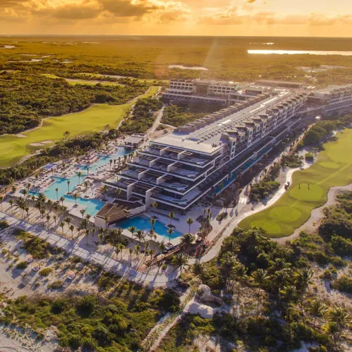 Aerial overview of Atelier Playa Mujeres property and pools at sunset, Cancun