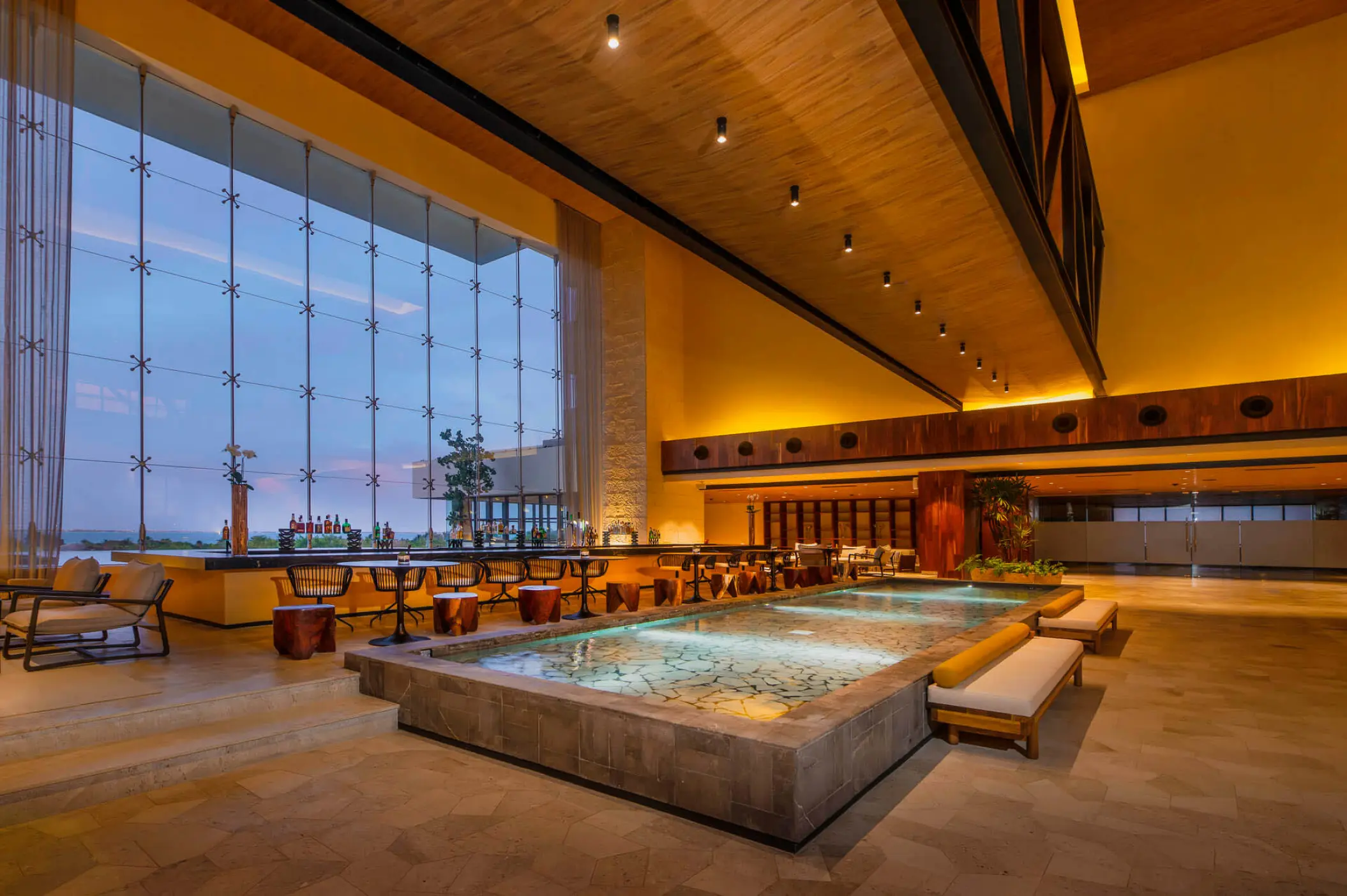 Atelier Playa Mujeres lobby bar Don Fernando with decorative water feature and large windows, Cancun