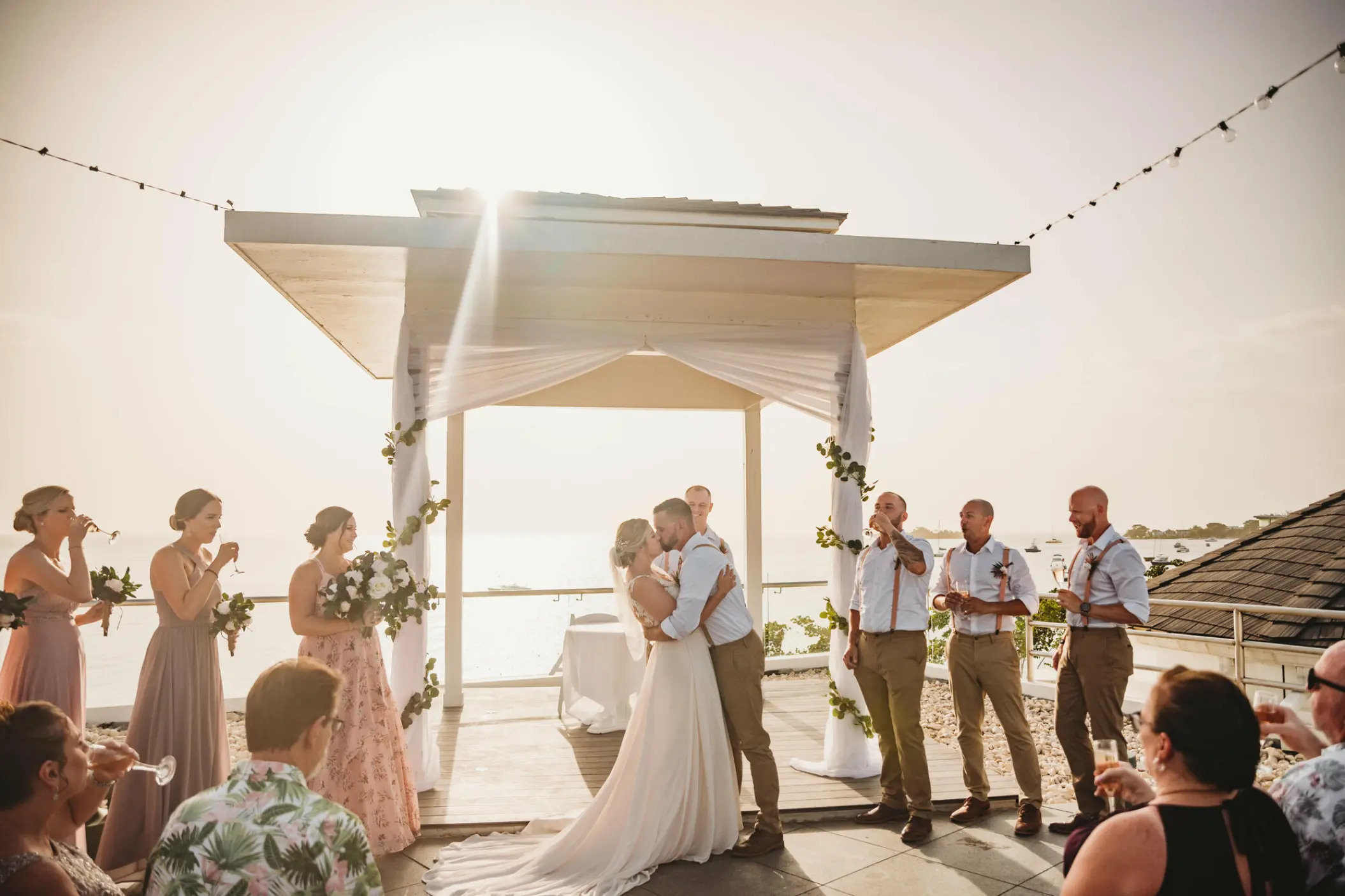 The bride and groom kissing during their wedding ceremony at Azul Beach Negril, Jamaica