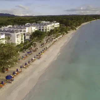 Aerial view of the white sand beach and beachfront buildings at Azul Beach Resort Negril, Negril
