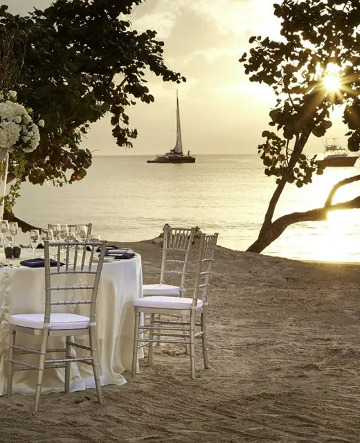 Beachfront wedding reception table at Azul Beach Resort Negril at sunset, Jamaica