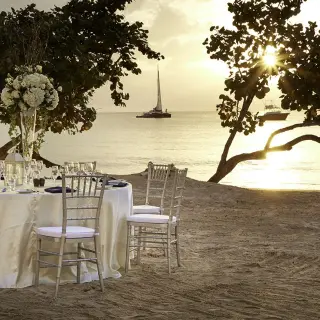 Beachfront wedding reception table at Azul Beach Resort Negril at sunset, Jamaica