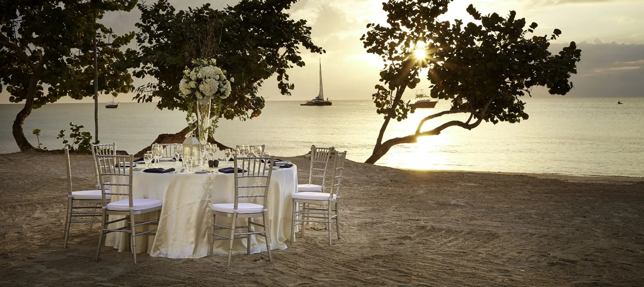 Beachfront wedding reception table at Azul Beach Resort Negril at sunset, Jamaica