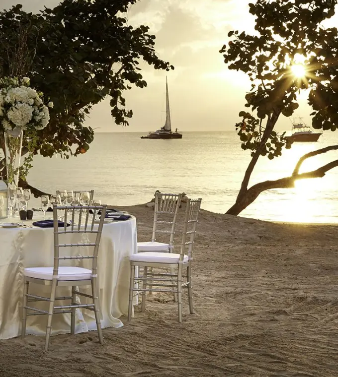 Beachfront wedding reception table at Azul Beach Resort Negril at sunset, Jamaica