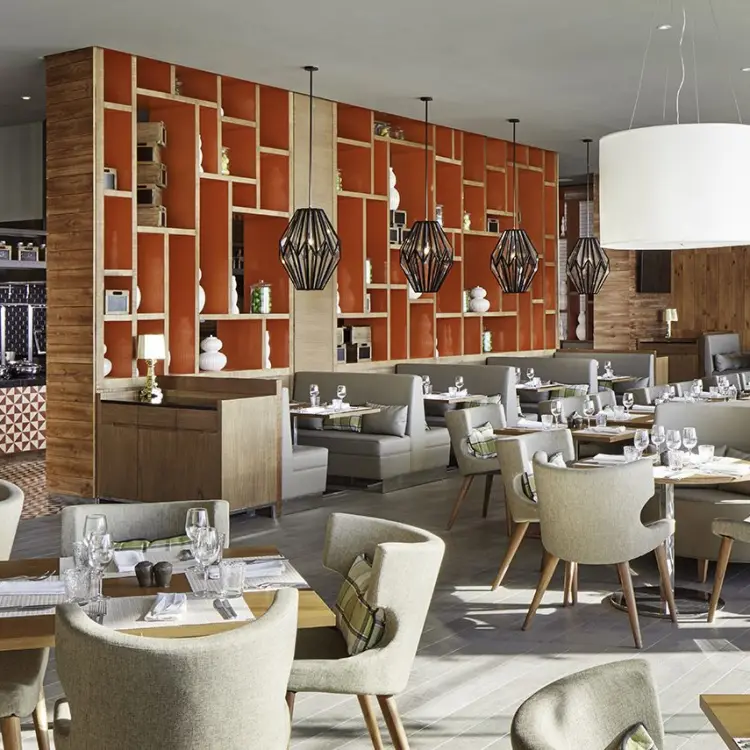 Modern buffet dining room with wood paneling and orange geometric shelves at Azul Beach Resort Negril