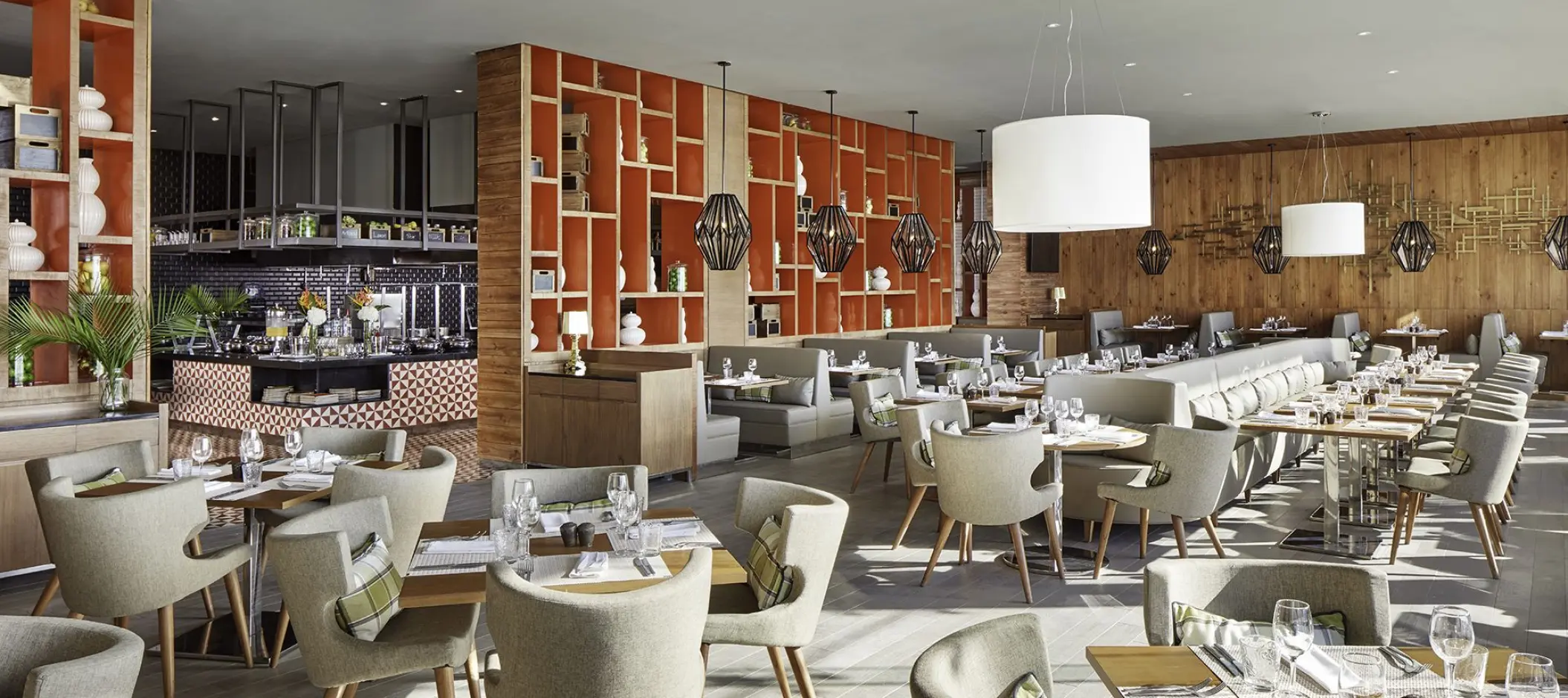 Modern buffet dining room with wood paneling and orange geometric shelves at Azul Beach Resort Negril