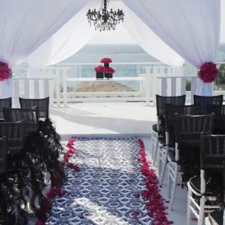 Rooftop terrace wedding ceremony setup with white huppah and ocean views at Azul Beach Resort Negril, Negril