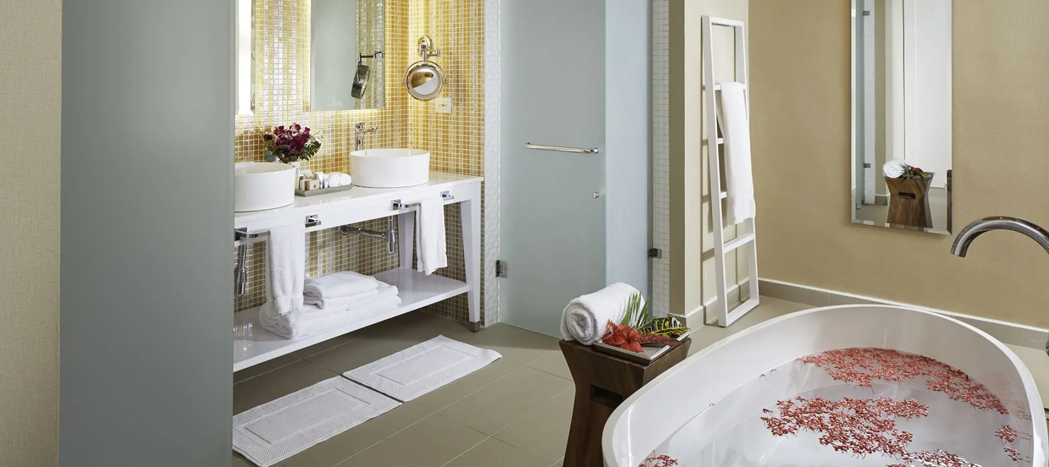 Azul Beach Resort Negril guest suite bathroom with flower petals in a soaking tub, Negril