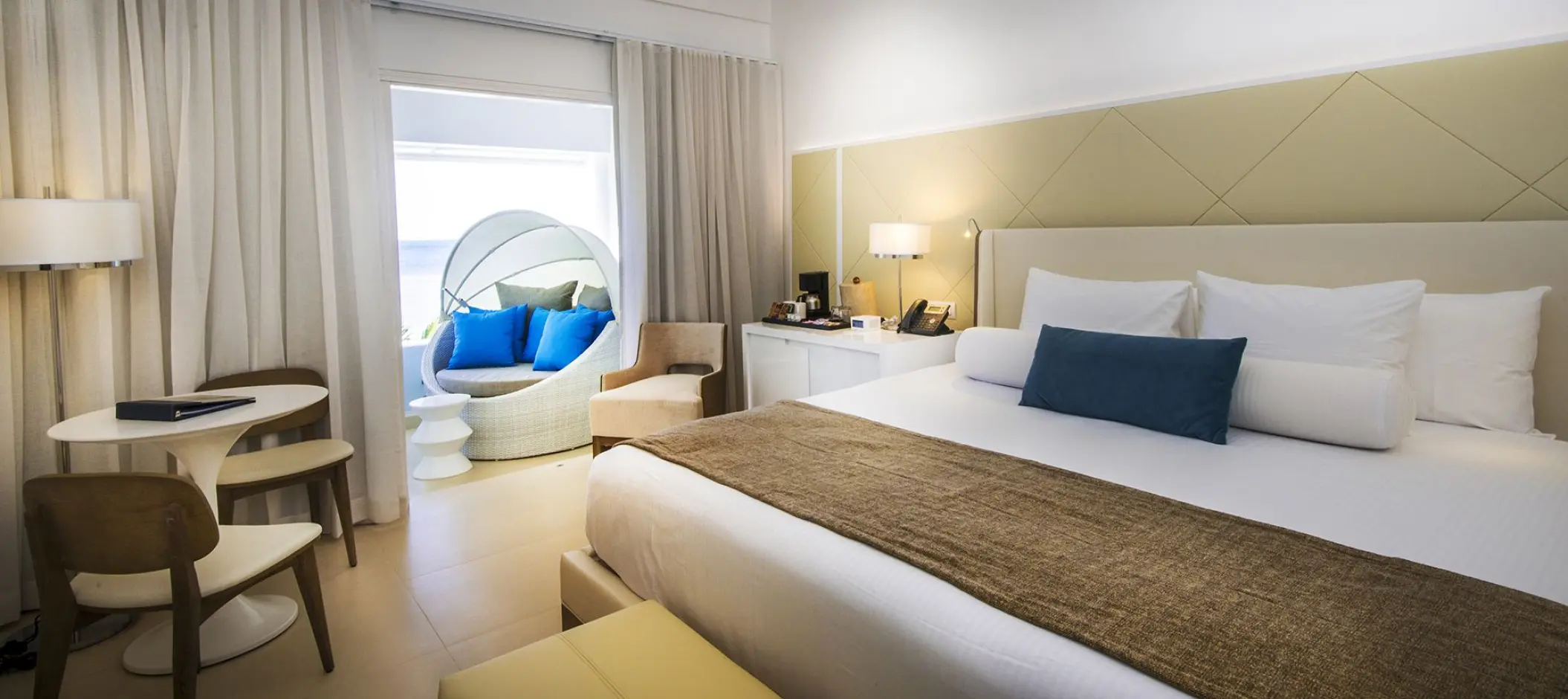 Modern guest suite with a balcony and ocean view at Azul Beach Resort, Negril