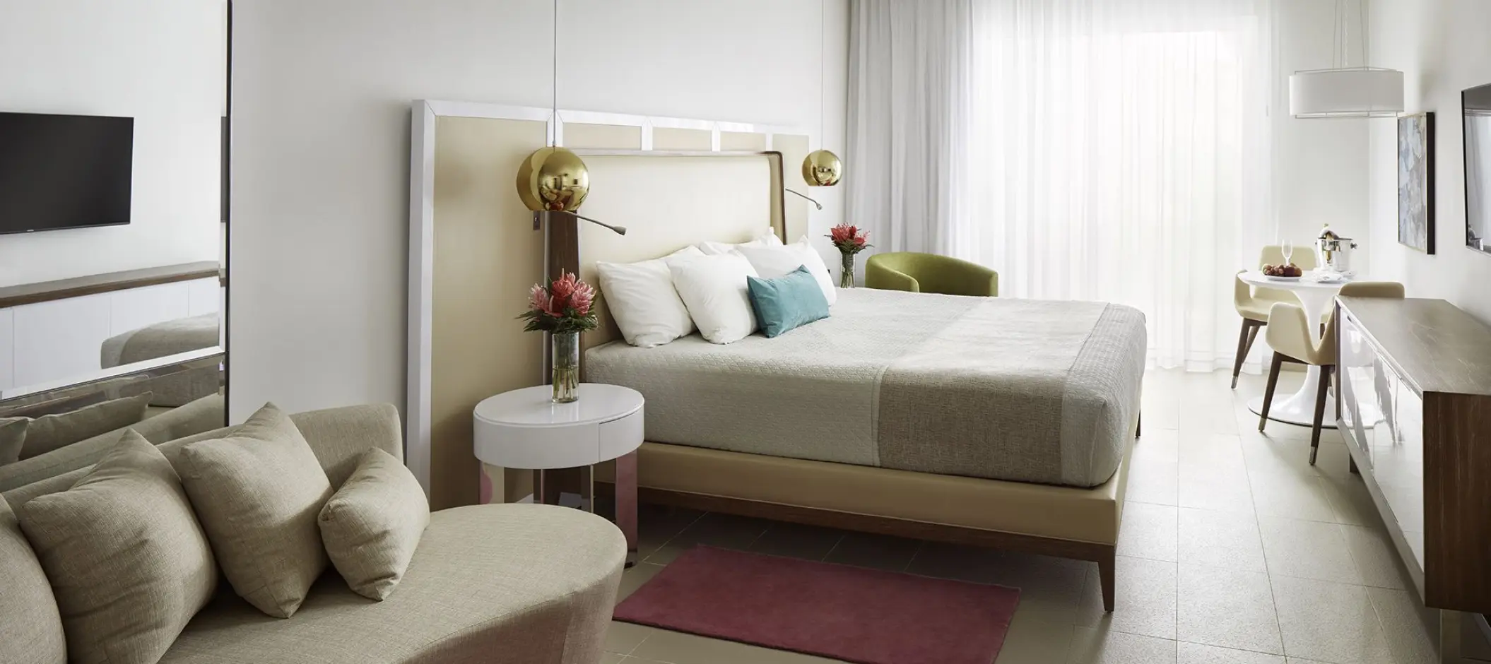 Modern hotel suite with a large bed and sitting area at Azul Beach Resort Negril, Negril