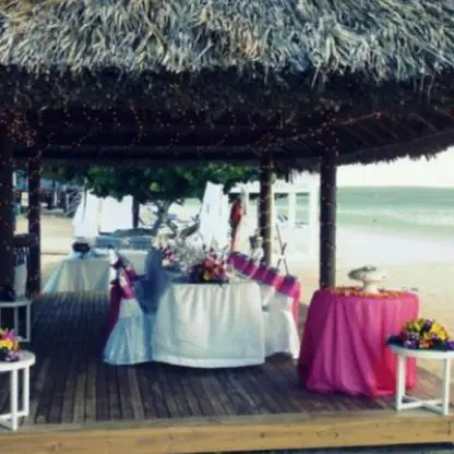 Beachfront wedding reception under a palapa hut at Azul Beach Resort, Negril