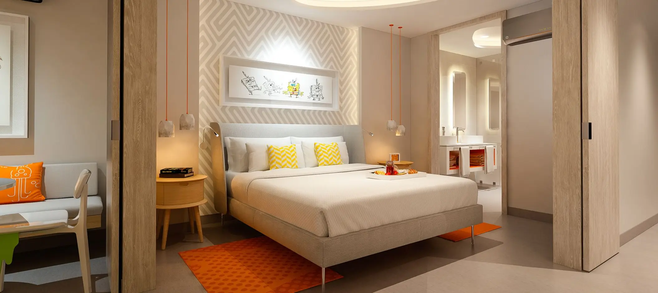 Modern suite with orange accents and a king bed at Nickelodeon Riviera Maya