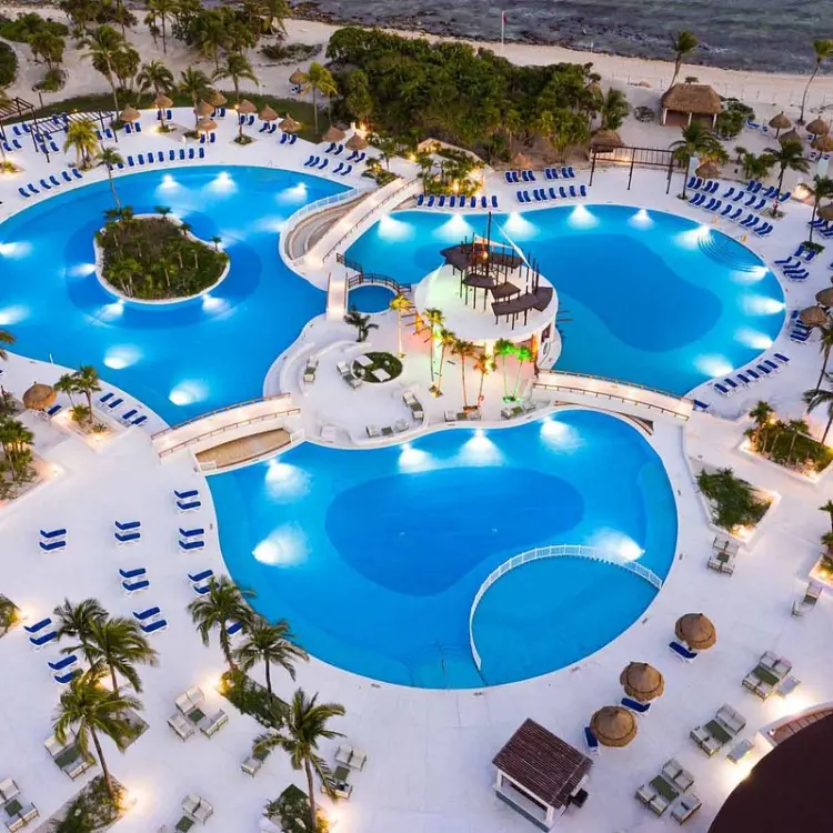 Aerial view of the illuminated main pool area at Bahia Principe Grand Tulum