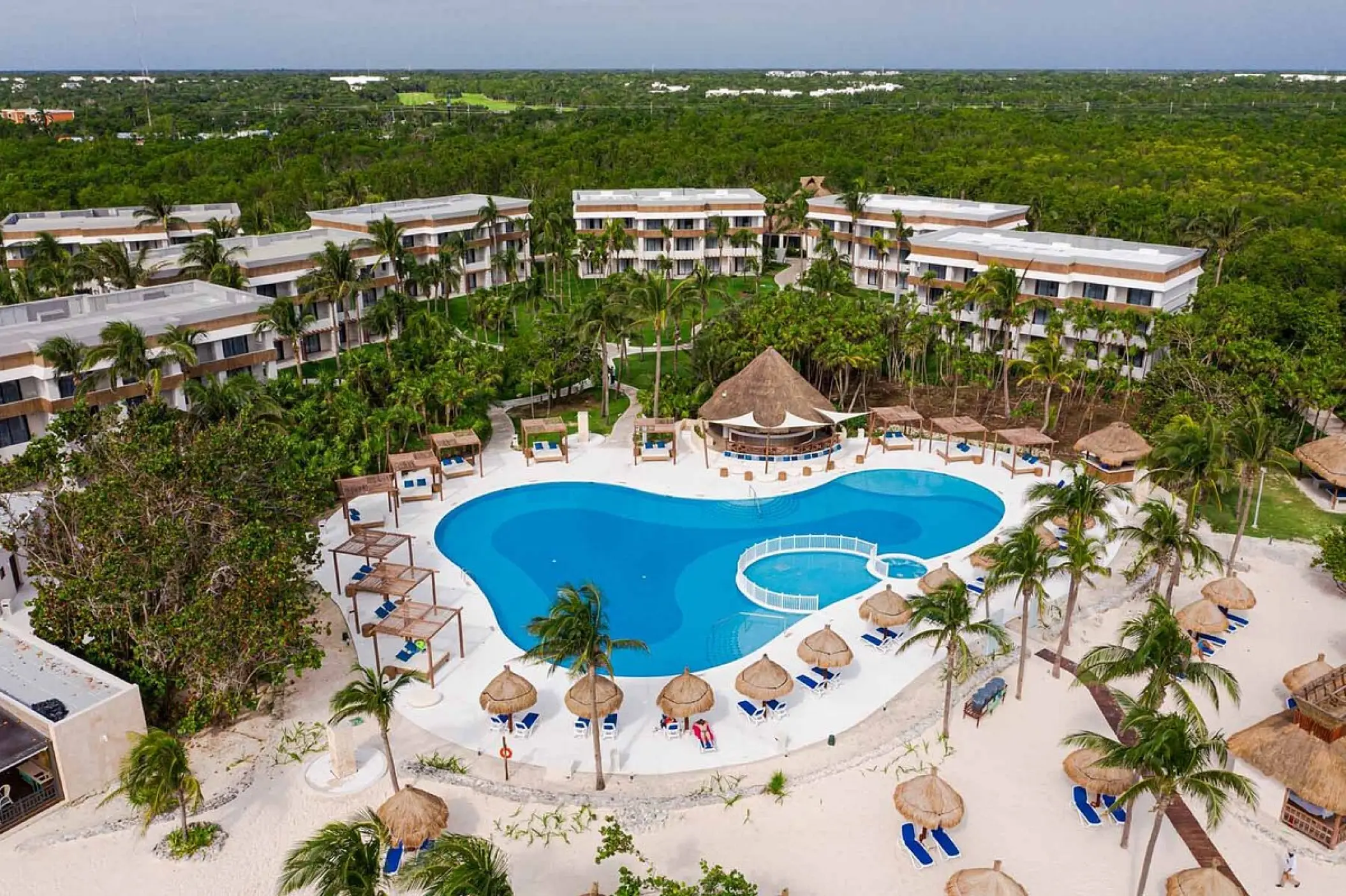 Aerial view of the swimming pool and guest buildings at Bahia Principe Grand, Tulum
