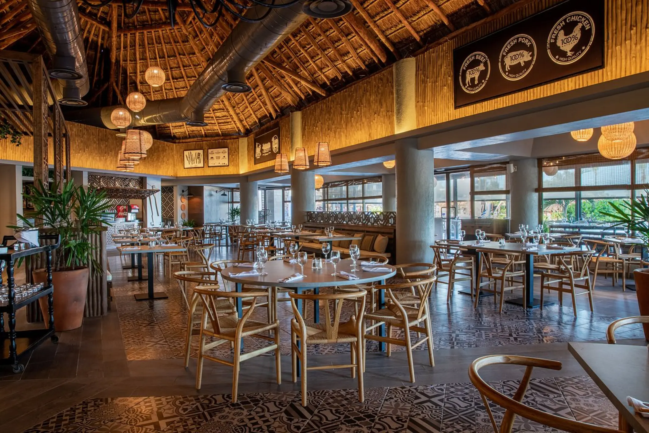 Bahia Principe Grand Tulum restaurant with a palapa roof and modern seating, Tulum
