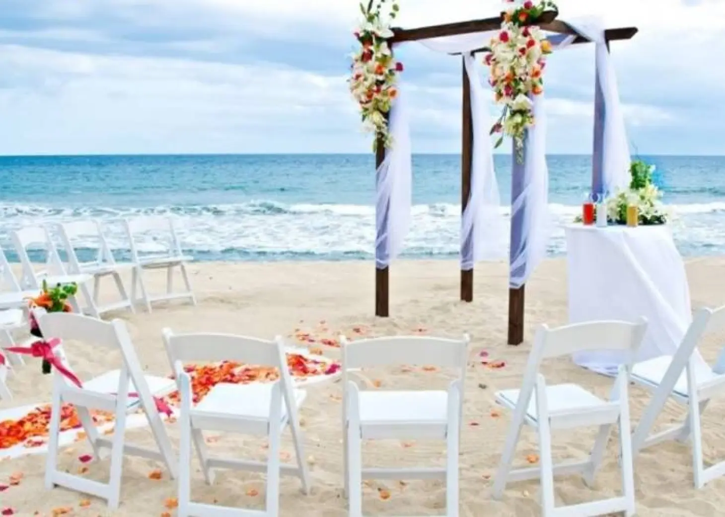 Beachfront wedding ceremony with a floral wooden gazebo at Barcelo Gran Faro Los Cabos, Cabo San Lucas