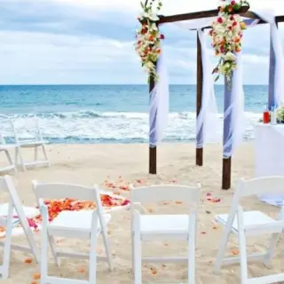 Beachfront wedding ceremony with a floral wooden gazebo at Barcelo Gran Faro Los Cabos, Cabo San Lucas