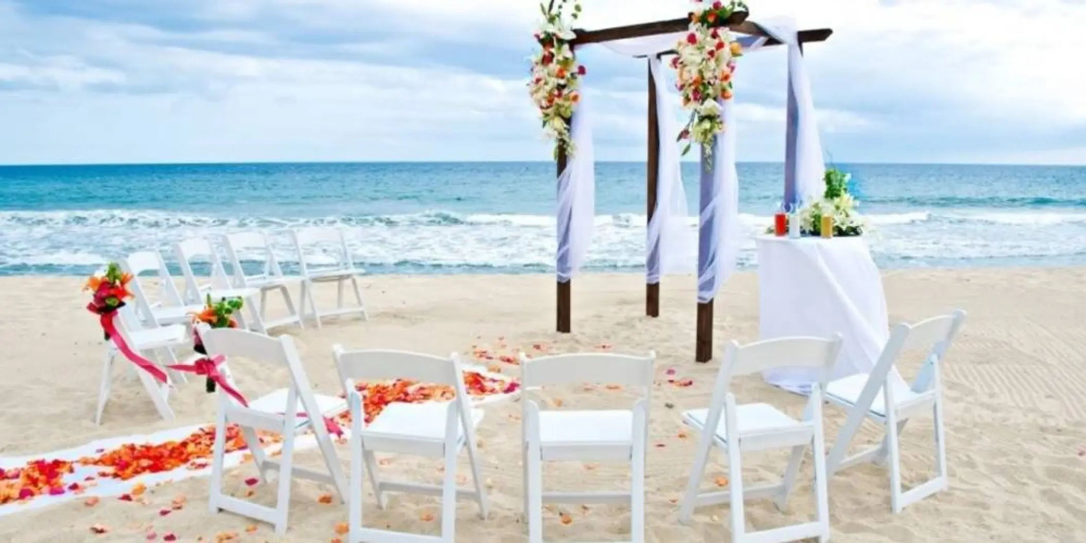 Beachfront wedding ceremony with a floral wooden gazebo at Barcelo Gran Faro Los Cabos, Cabo San Lucas