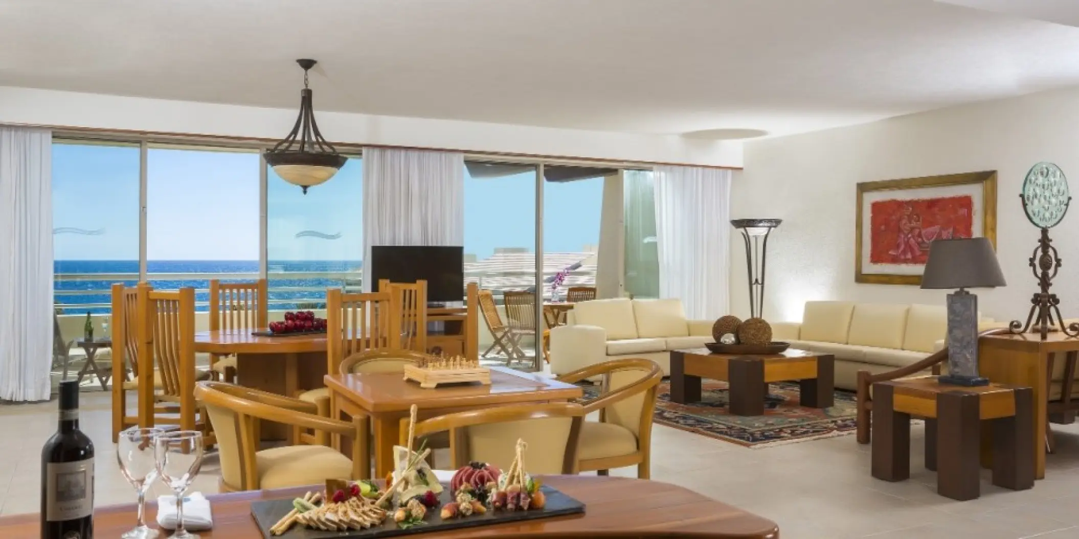 Living room suite with wooden furniture and ocean views at Barcelo Gran Faro, Cabo San Lucas