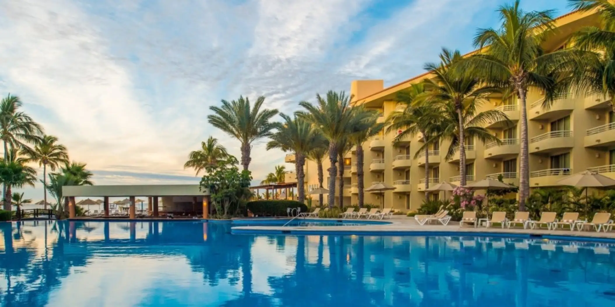 Large outdoor pool and palm trees at Barcelo Gran Faro Los Cabos, Cabo San Lucas