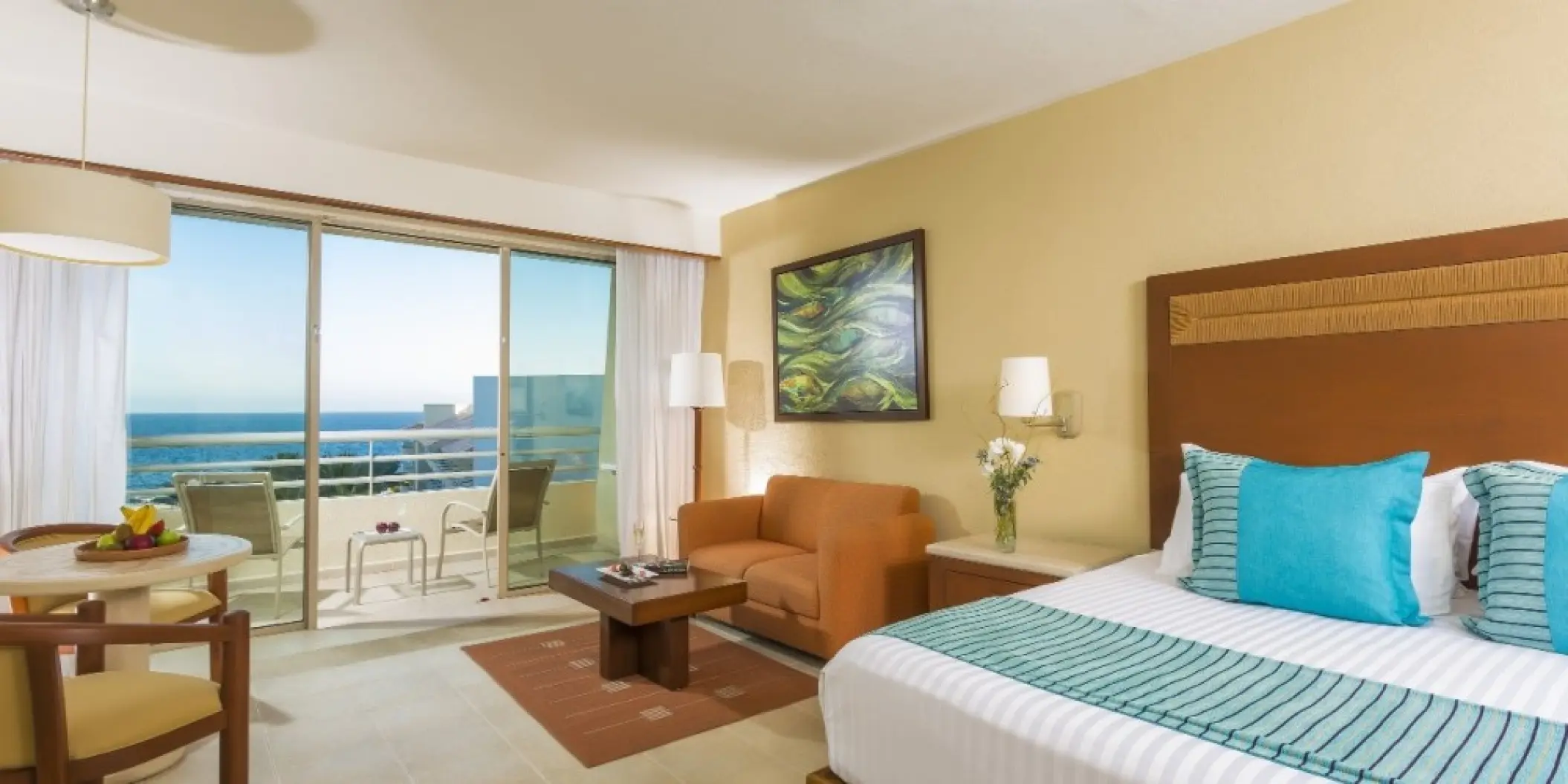 Oceanfront suite with a private balcony and seating area at Barcelo Gran Faro, Cabo San Lucas