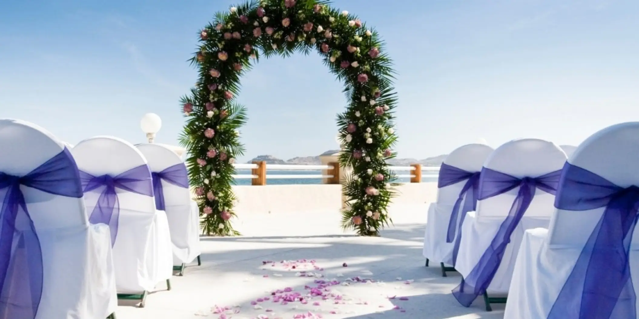 Floral arch at a terrace wedding ceremony at Barcelo Gran Faro Los Cabos, Cabo San Lucas