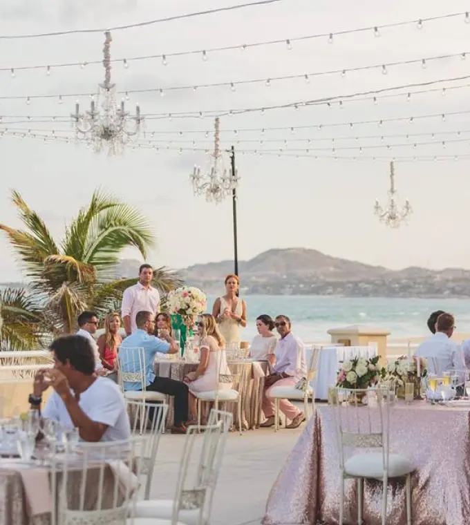 Rooftop wedding reception with chandeliers and string lights at Barcelo Gran Faro Los Cabos, Cabo San Lucas