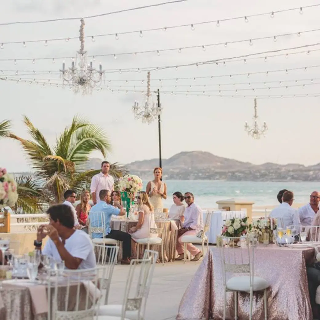 Rooftop wedding reception with chandeliers and string lights at Barcelo Gran Faro Los Cabos, Cabo San Lucas