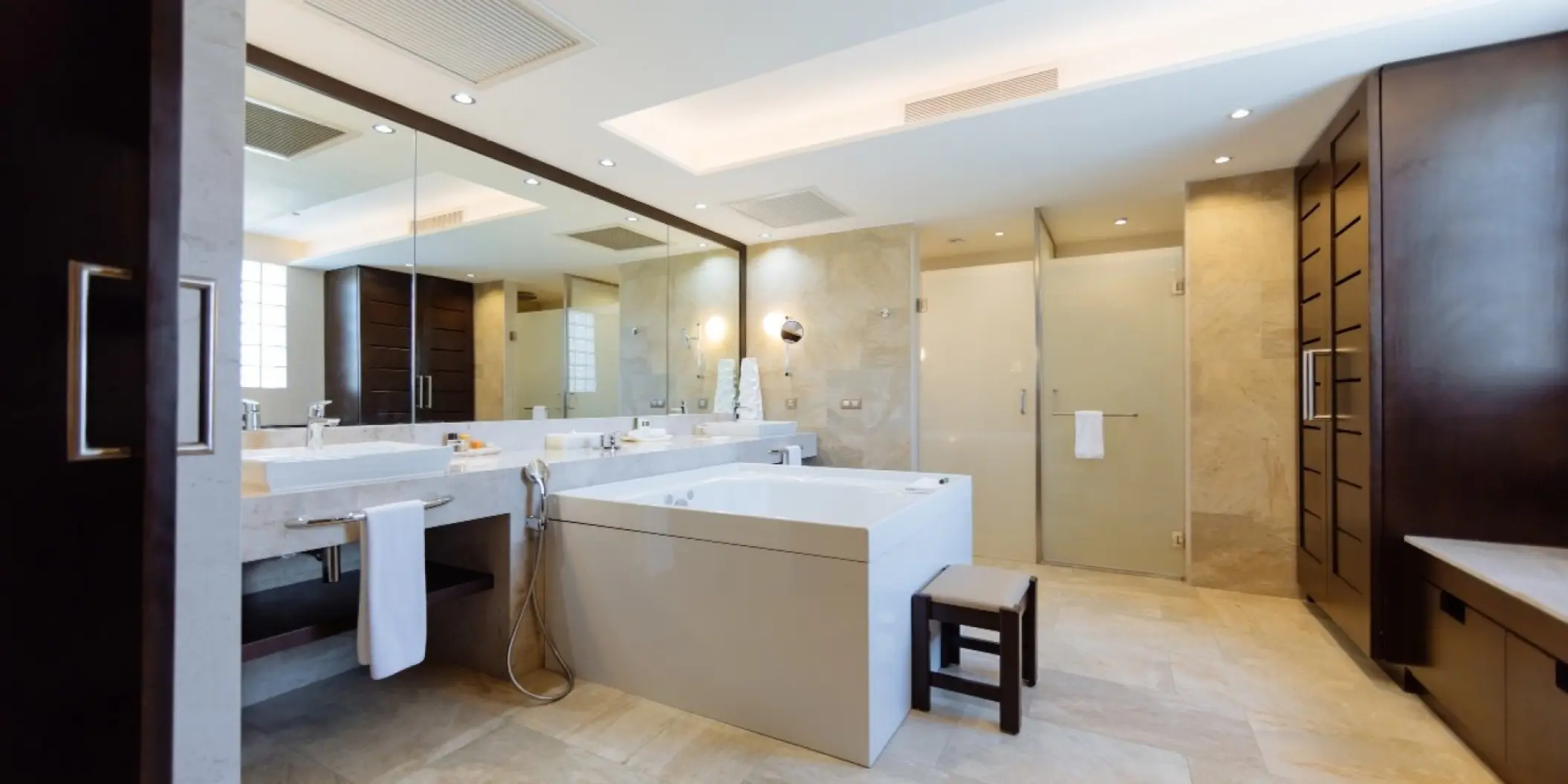 Modern bathroom with a large soaking tub and double vanity at Barcelo Maya Caribe, Riviera Maya