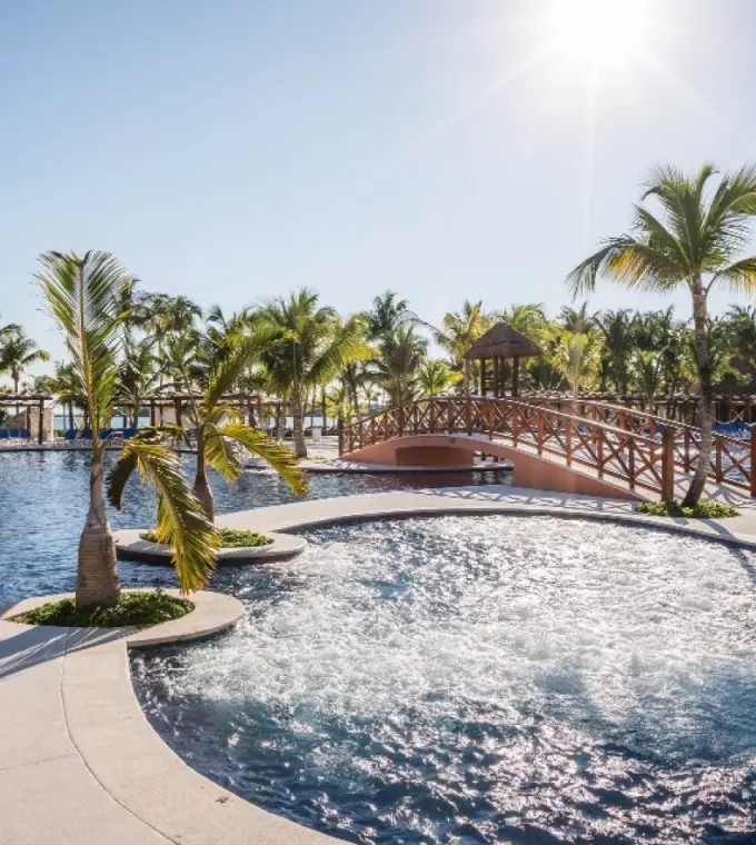 Barcelo Maya Caribe swimming pools with palm trees and footbridge, Riviera Maya