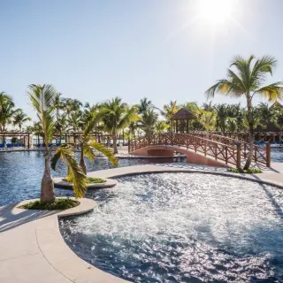 Barcelo Maya Caribe swimming pools with palm trees and footbridge, Riviera Maya