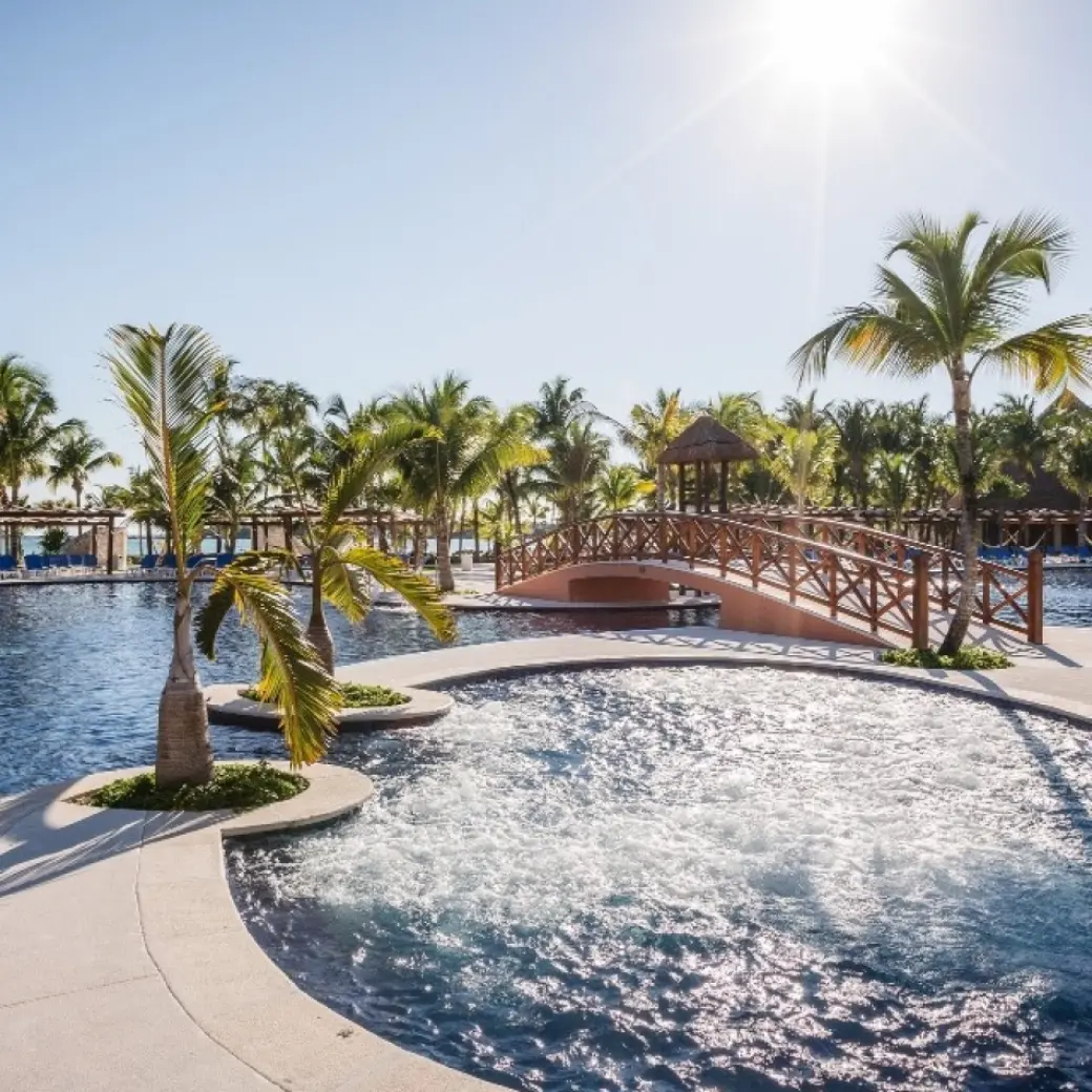 Barcelo Maya Caribe swimming pools with palm trees and footbridge, Riviera Maya
